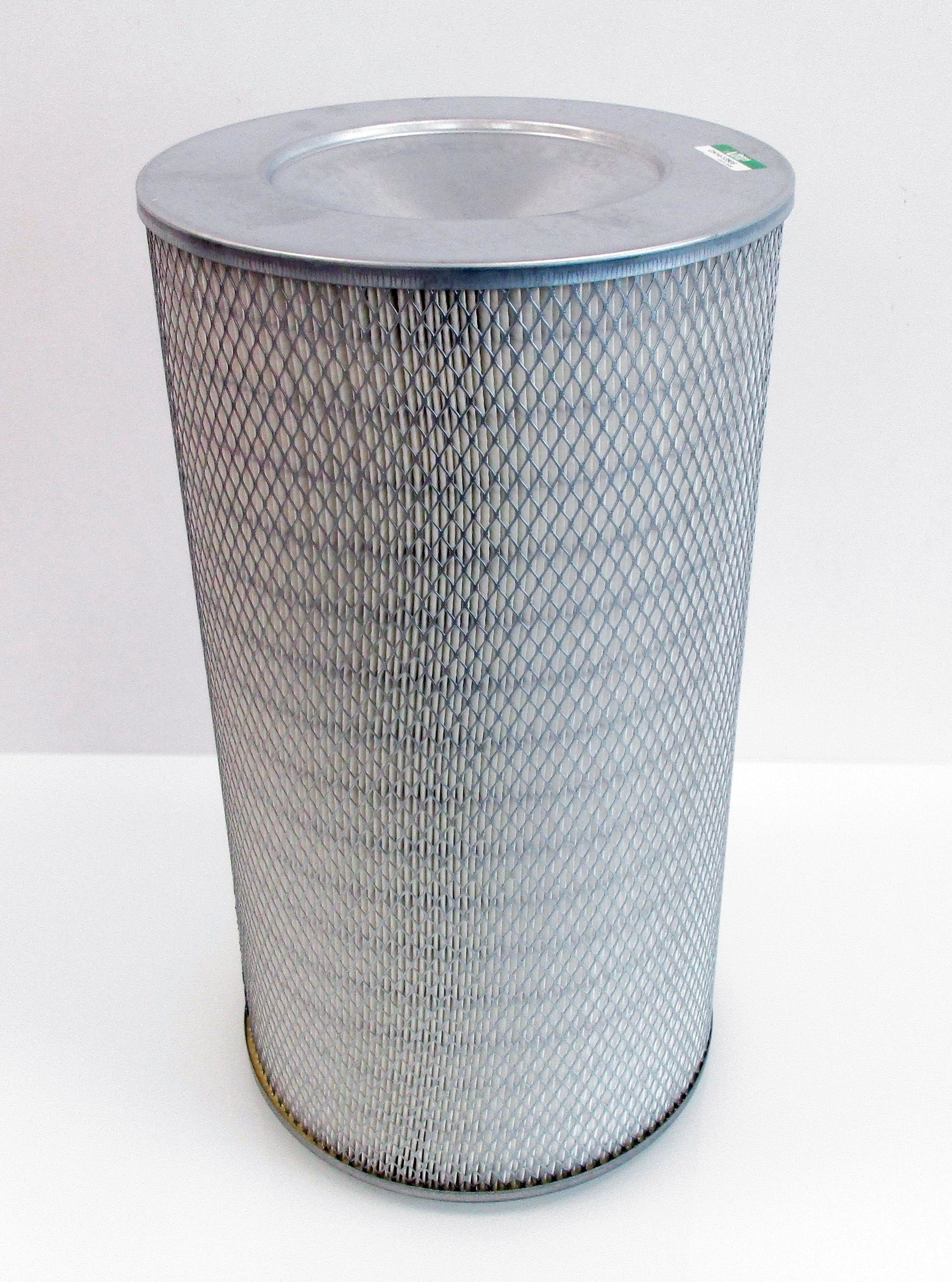A cylindrical metal air filter with a grey mesh body and a flat metal top, photographed on a plain white background.