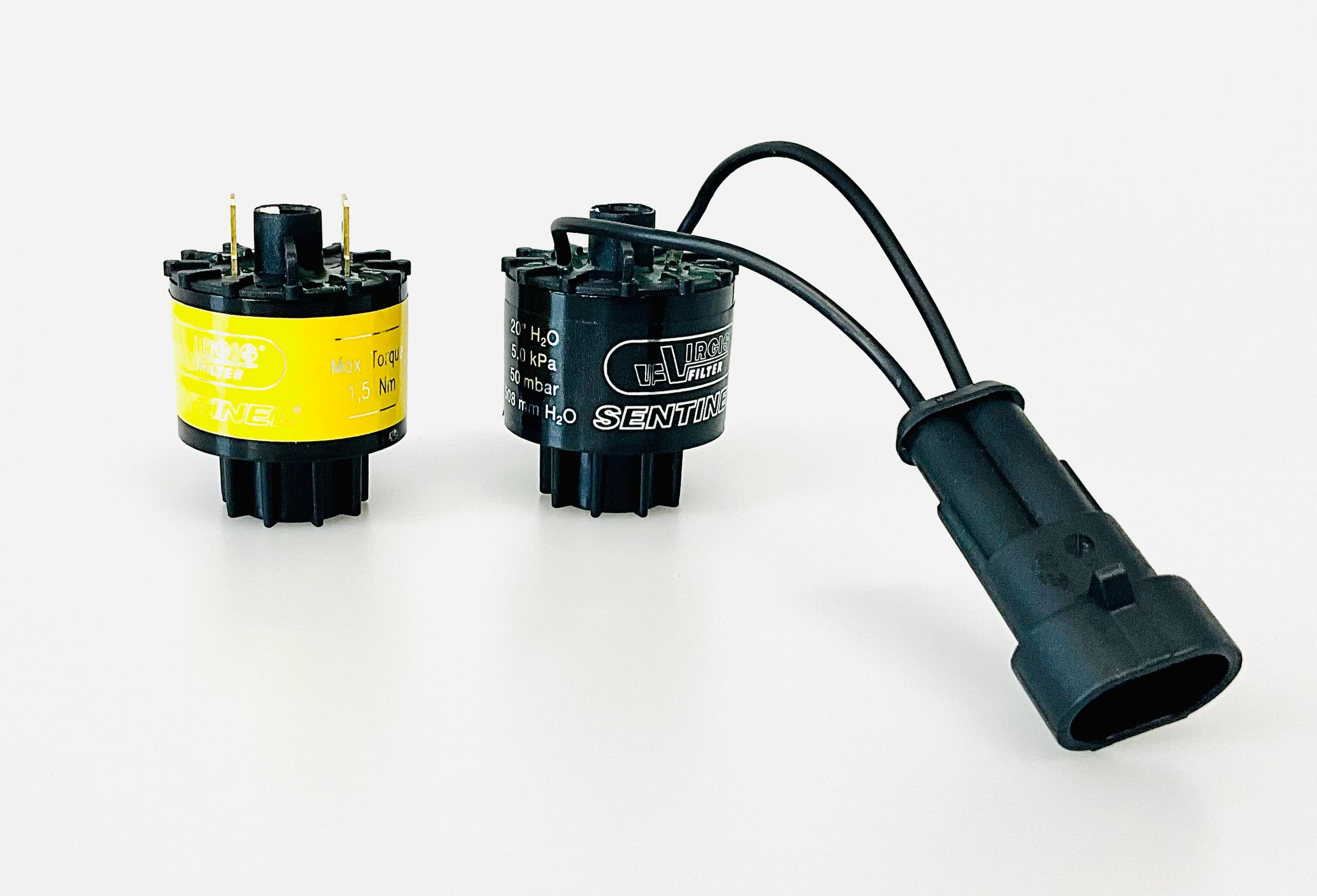 Two small cylindrical indicators. One has a yellow label with connections. The other has a black label with attached black wiring and a connector., shown on a white background.