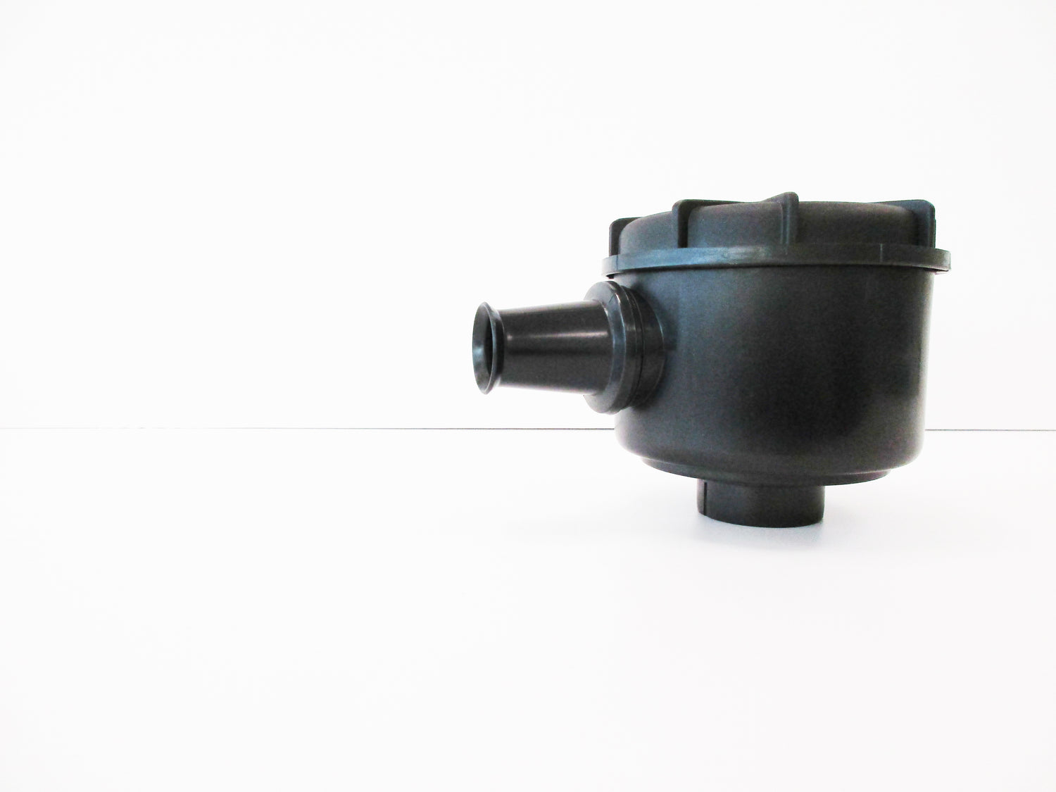 A black plastic single stage air cleaner with inlet spout, shown on a plain white background.