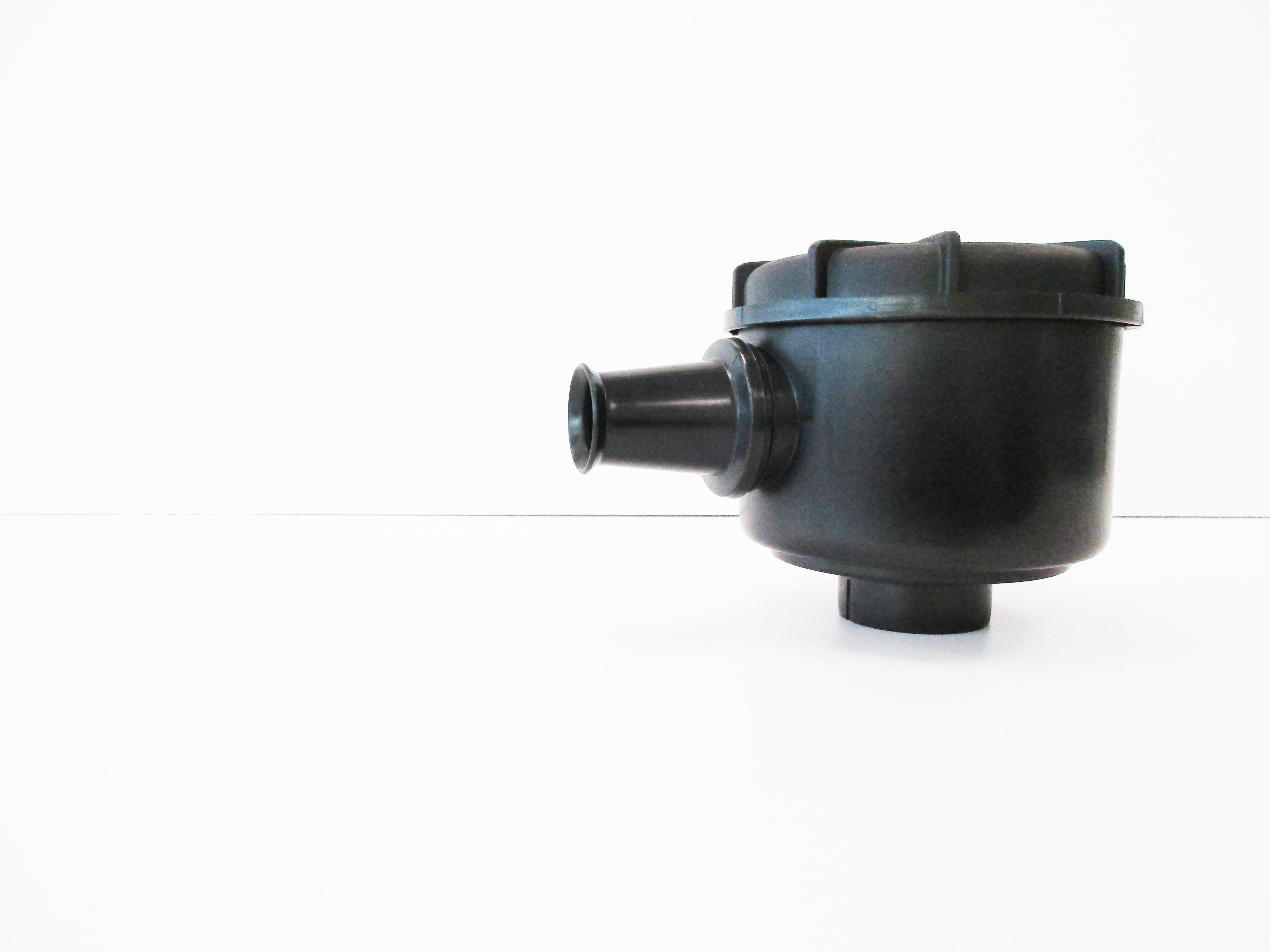 A black plastic single stage air cleaner with inlet spout, shown on a plain white background.