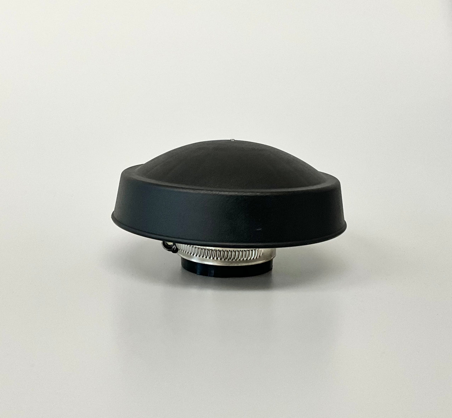 A black dome-shaped rain cap with a grey metal clamp, shown on a neutral light grey background.
