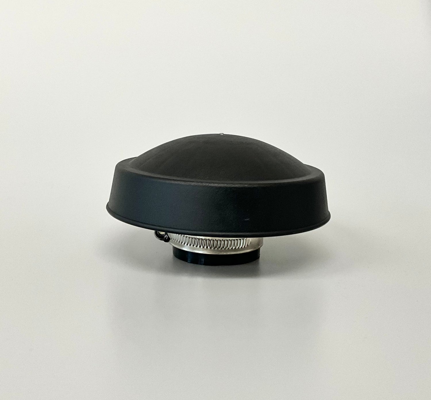 A black dome-shaped rain cap with a grey metal clamp, shown on a neutral light grey background.