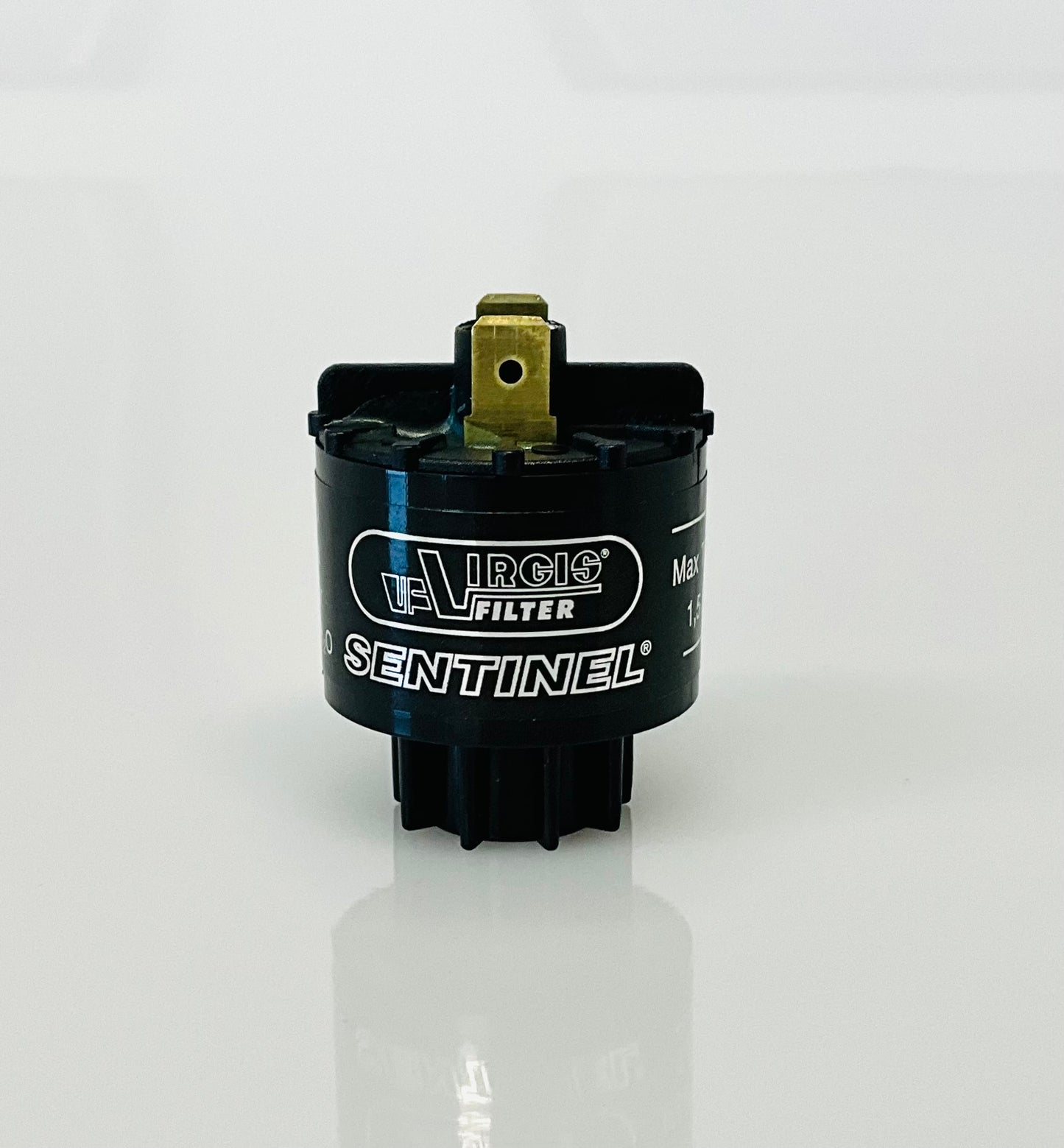 A small black cylindrical electrical indicator with two metal pins at the top, labelled 'Virgis Filter' and 'Sentinel', shown on a reflective white surface.