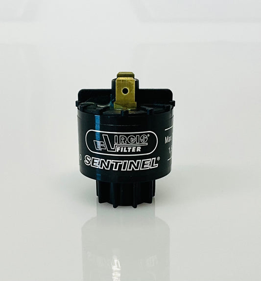 A small black cylindrical electrical indicator with two metal pins at the top, labelled 'Virgis Filter' and 'Sentinel', shown on a reflective white surface.