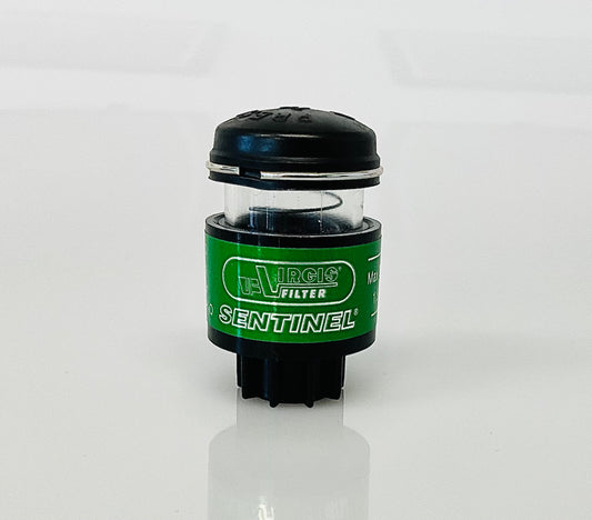 A small black cylindrical optical indicator with press button top, with a green label labelled 'Virgis Filter' and 'Sentinel', shown on a reflective white surface.