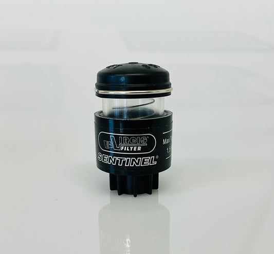 A small black cylindrical optical indicator with press button top, labelled 'Virgis Filter' and 'Sentinel', shown on a reflective white surface.