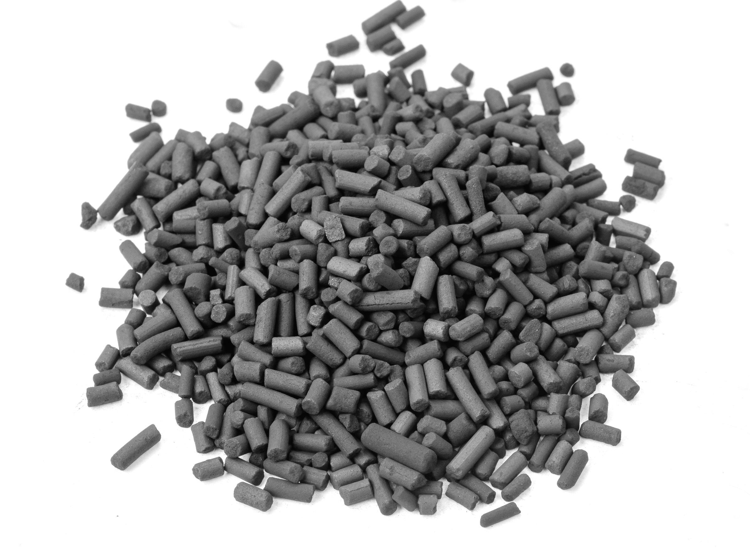 A pile of dark grey cylindrical carbon granules, shown on a white background.